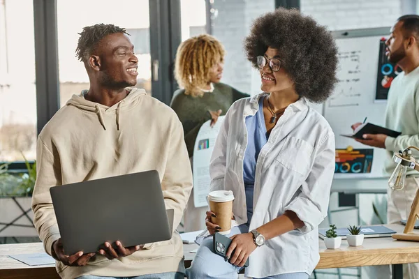 Young african american friends working actively on their project with laptop and graphs, business — Stock Photo