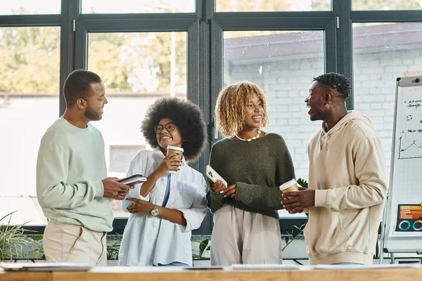 Cheerful young team of friends discussing actively their project on coffee break, working process — Stock Photo