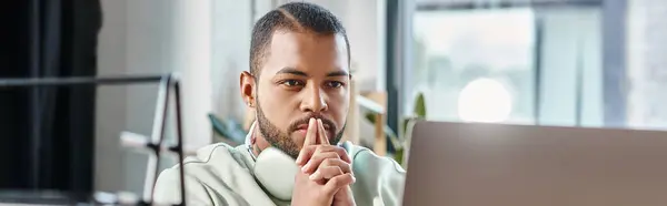 Thoughtful man with headphones looking at his laptop with fingers near face, working process, banner — Stock Photo