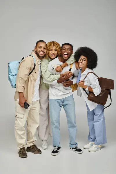 African american friends with backpacks hugging warmly and smiling at camera, studying concept — Stock Photo