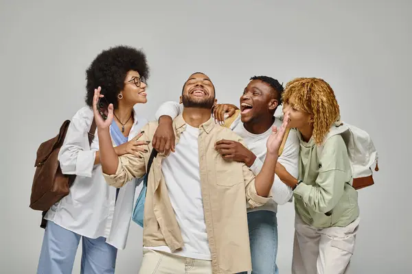Cheerful young students having great time laughing and gesturing actively, studying concept — Stock Photo