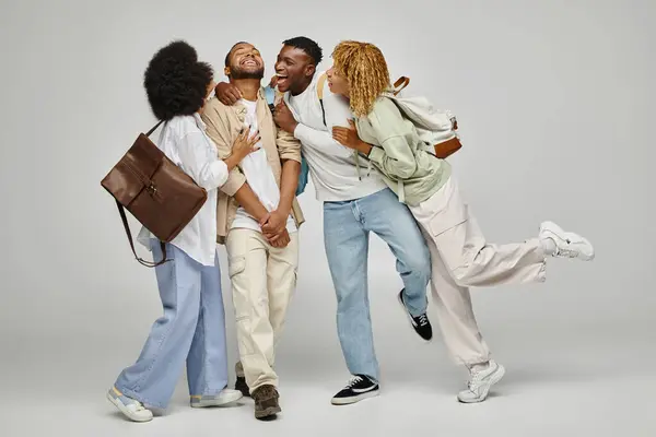 Joyous african american friends hugging warmly and laughing sincerely together, student lifestyle — Stock Photo