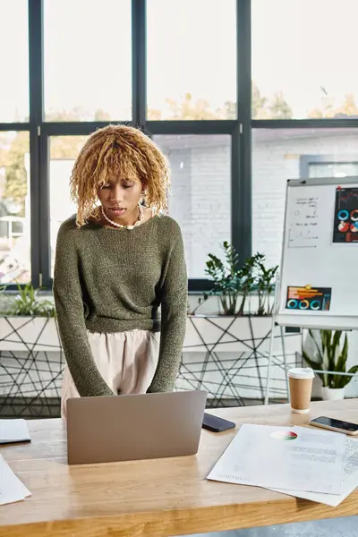 Attraktive Frau in Freizeitkleidung arbeitet an Projekt mit Laptop mit Grafiken auf Hintergrund, Geschäft — Stockfoto