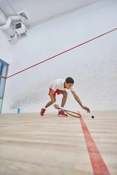Sportif afro-américain actif jouant au squash à l'intérieur du court, défi et motivation — Photo de stock
