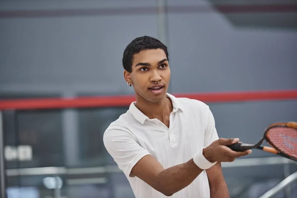 Pierced african american sportsman playing squash inside of court, challenge and motivation — Stock Photo