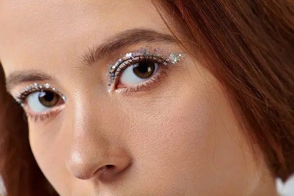 Close up portrait of woman with holiday makeup looking at camera, shiny silver eye shadow — Stock Photo