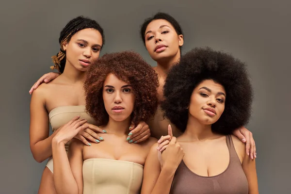 Attractive young african american women in pastel underwear looking at camera, fashion concept — Stock Photo