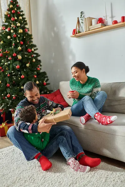 Vertical shot of happy african american family in warm sweaters spending time together, Christmas — Stock Photo