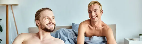 Cheerful gay couple smiling in cozy bedroom in morning, serenity and harmonious relationship, banner — Stock Photo