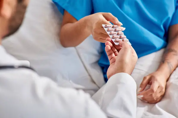 Cropped view of indian doctor giving pills to his ill african american female patient, healthcare — Stock Photo