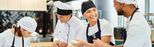 Gioioso chef sorridente al suo collega afroamericano con amico e capo cuoco sullo sfondo, banner — Stock Photo