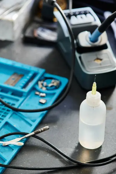 Plastic bottle and professional testing equipment on table in repair shop, maintenance service — Stock Photo
