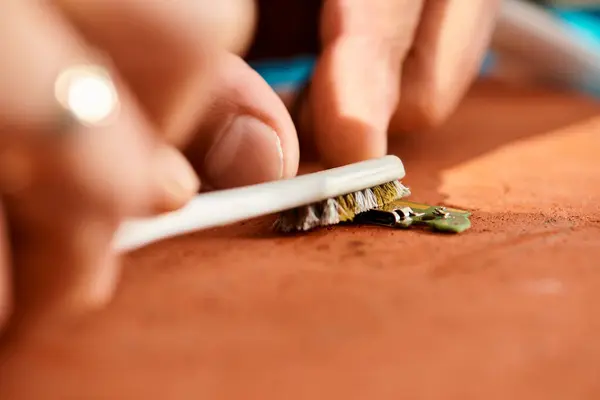 Close up view of professional repairman cleaning chipset with brush in workshop, small business — Stock Photo