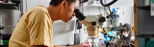 Asian technician working with microscope at workplace in repair shop, small business, banner — Stock Photo