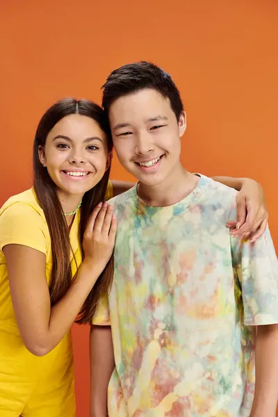 Joyful diverse teenagers in bring attires having fun and looking at camera, friendship day — Stock Photo