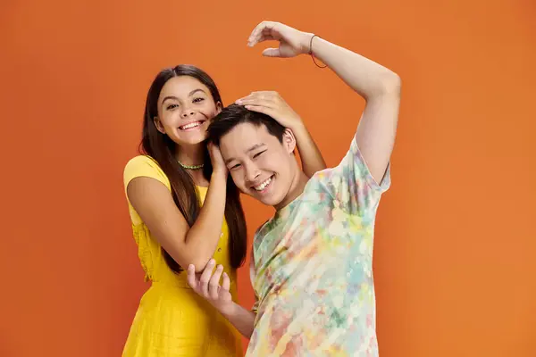 Jolly interracial teenagers in vibrant outfits having fun and smiling at camera, friendship day — Stock Photo