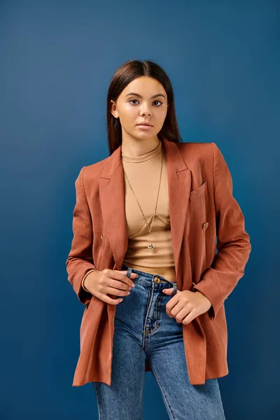 Adorable stylish adolescent girl in brown elegant blazer posing and looking straight at camera — Stock Photo