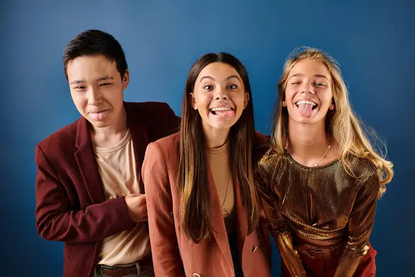 Joyous multicultural teens in fashionable clothes smiling happily at camera, friendship day — Stock Photo