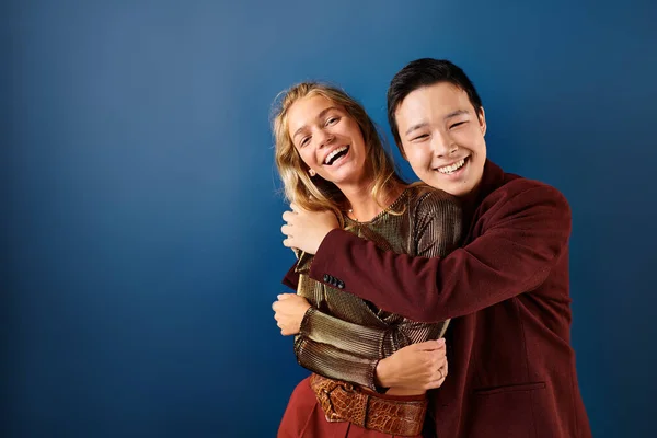Joyous multiracial teenage boy and girl hugging and smiling happily at camera, friendship day — Stock Photo