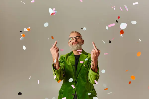 Good looking funky mature man in green blazer showing middle fingers at camera with closed eyes — Stock Photo