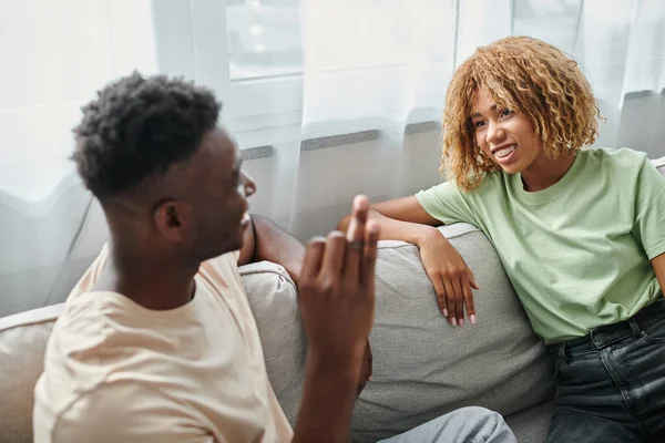 Sign language, joyful african american woman in braces looking at boyfriend showing hand gesture — Stock Photo