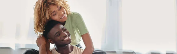 Freudige afrikanisch-amerikanische Frau umarmt Freund im Wohnzimmer, Qualitätszeit des Paares Banner — Stockfoto