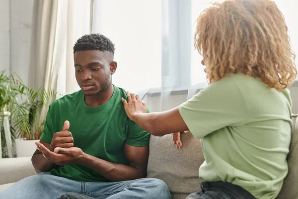 Black man showing help gesture while communicating with girlfriend and using sign language — Stock Photo