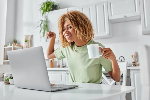 Happy african american woman using sign language during video call and holding cup, nonverbal — Stock Photo