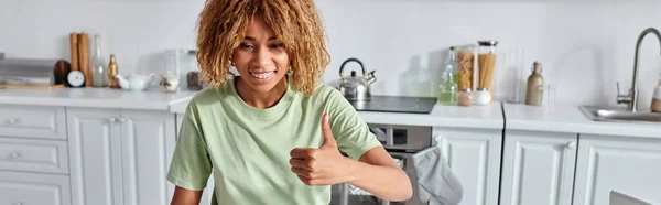 Happy african american woman showing thumb up during video call on laptop, like gesture banner — Stock Photo