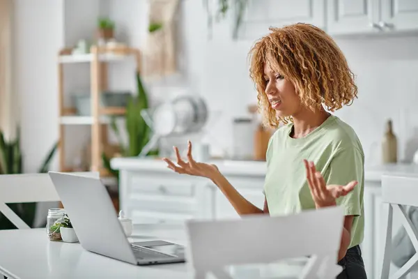 Encaracolado afro-americano mulher em aparelho usando linguagem de sinais durante chamada de vídeo no laptop, conexão — Fotografia de Stock