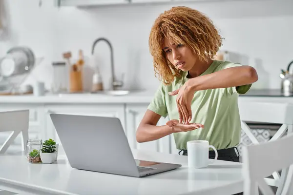 Focused african american woman in braces using sign language during video call on laptop, connection — Stock Photo