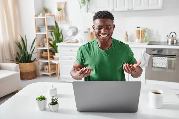 Positive african american deaf man using sign language during video call on laptop at home — Stock Photo