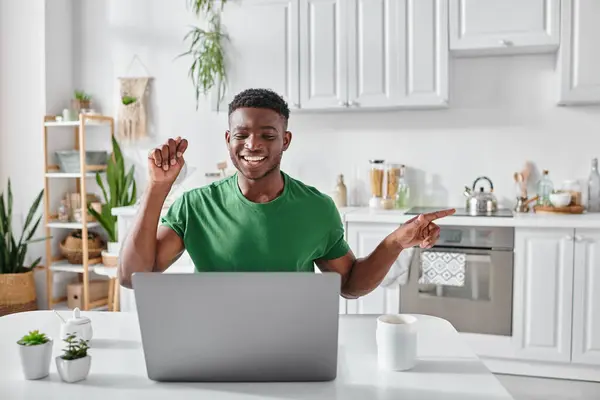 Positive deaf african american freelancer using sign language during video call on laptop at home — Stock Photo