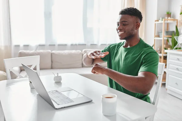 Joyful deaf african american freelancer using sign language for communication during video call — Stock Photo