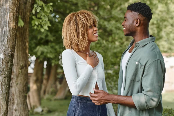 Sign language, happy african american couple holding hands and communicating with gestures outdoors — Stock Photo