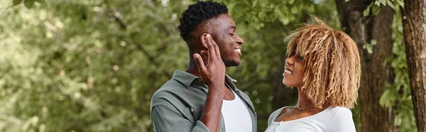 Sign language banner, positive african american couple communicating with gestures outdoors — Stock Photo