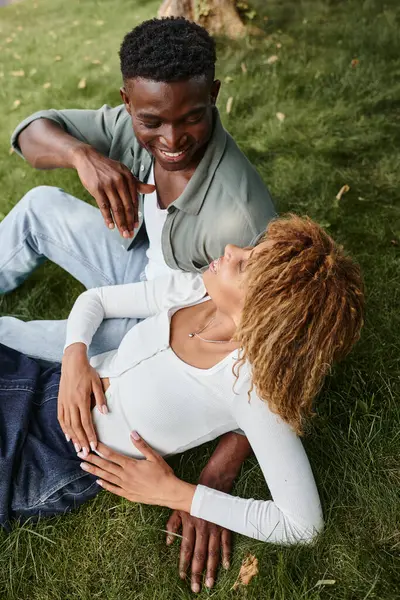 Top view of happy african american man using sign language for communication with girlfriend in park — Stock Photo