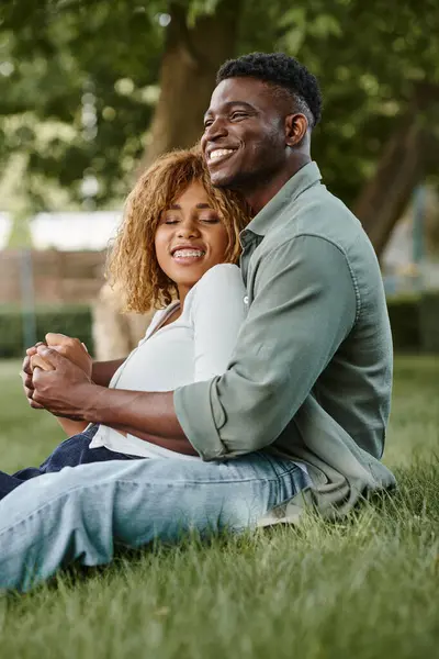 Cheerful african american couple spending quality time with each other in park, holding hands — Stock Photo