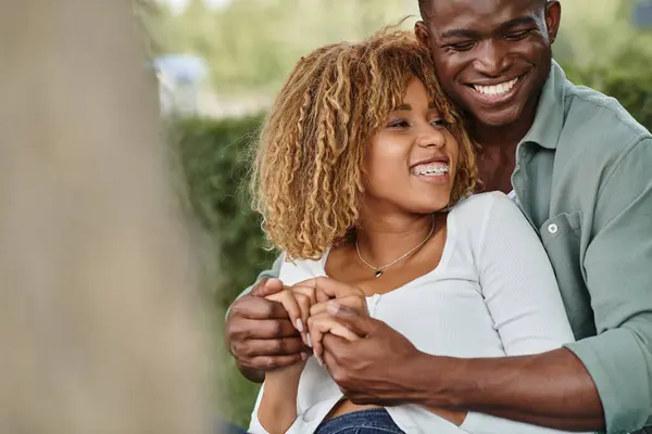 Excited african american couple spending quality time with each other in park, holding hands — Stock Photo