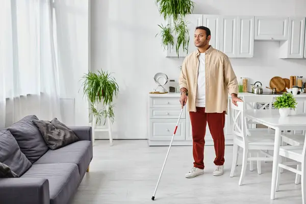 Attractive blind indian man in casual cozy homewear using walking stick while at home, disabled — Stock Photo