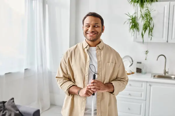 Cheerful blind indian man in casual comfy attire using his walking stick and smiling happily at home — Stock Photo