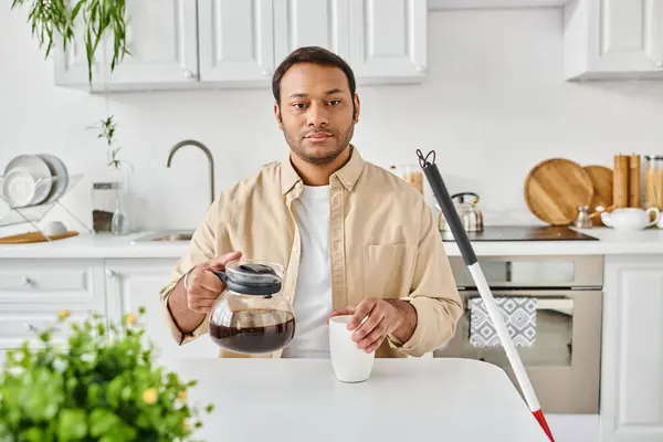 Indian blind good looking man in casual attire with walking stick sitting and pouring himself coffee — Stock Photo