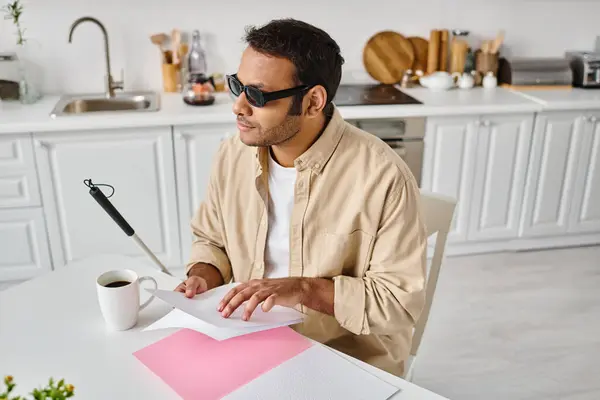 Good looking indian man with blindness with glasses and walking stick reading braille code — Stock Photo