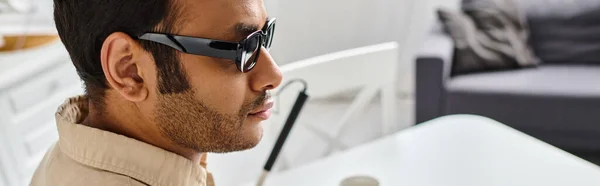 Handsome indian man with visual impairment in casual attire with glasses and walking stick, banner — Stock Photo