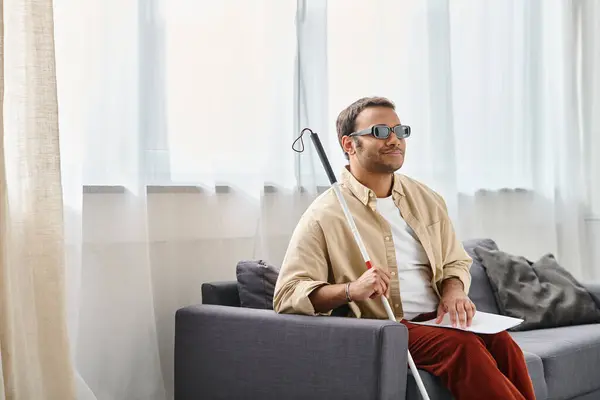 Joyous indian man with visual impairment with glasses and walking stick reading braille code — Stock Photo