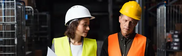 Banner of colleagues in safety vests walking in warehouse and planning work, logistic and cargo — Stock Photo