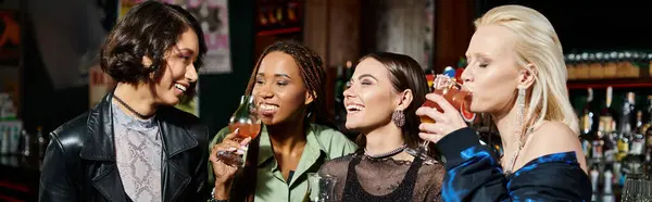 Счастливые и модные мультикультурные подруги, пьющие вкусные коктейли в баре, горизонтальный баннер — стоковое фото