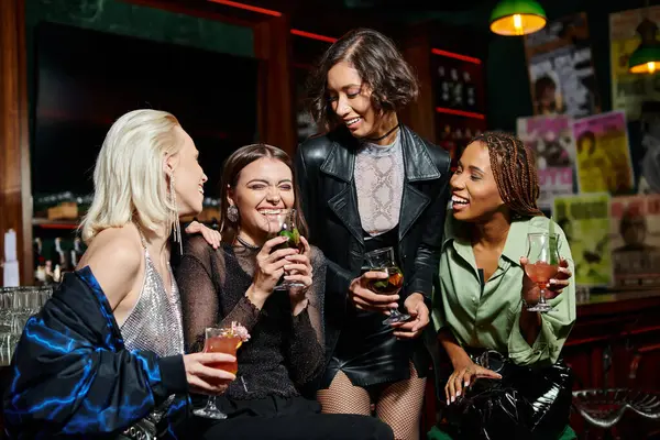 Gai asiatique femme debout avec cocktail verre près élégant multiethnique copines dans bar — Photo de stock