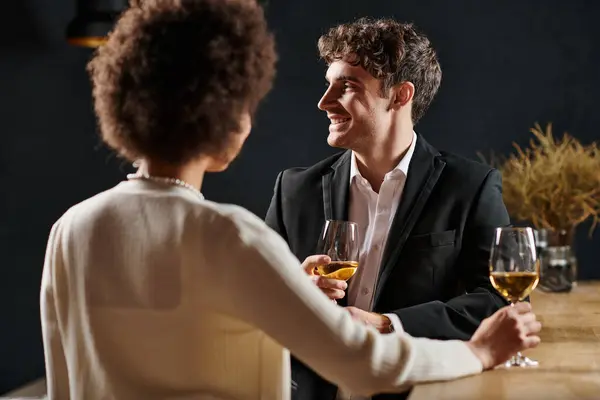 Focus on handsome man smiling while having a great time during date with girlfriend on valentines day — Stock Photo