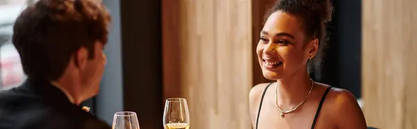 Happy african american woman looking at boyfriend during date on Valentines day, banner — Stock Photo